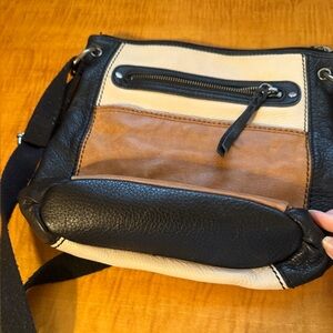 The Sak Laurel Crossbody Bag in a black, tan, and cream color-block design.
